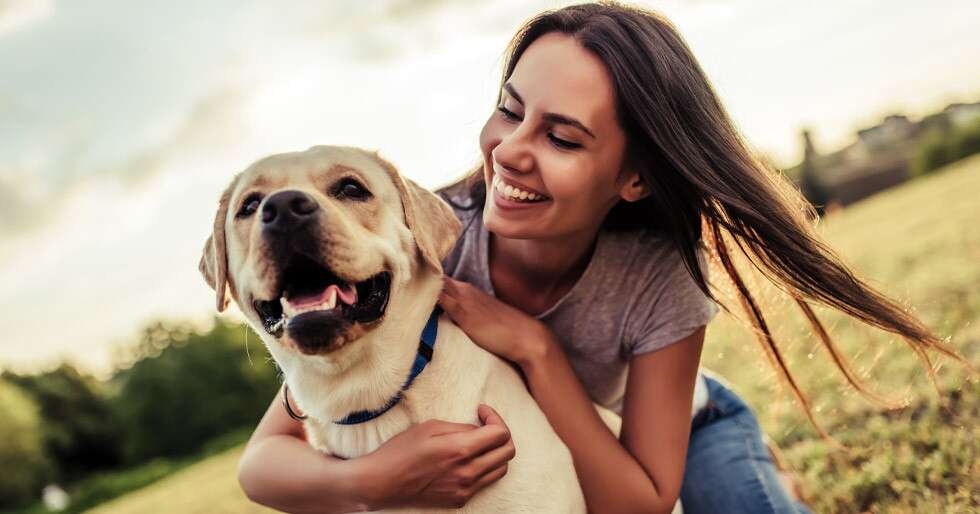 Happy dog owner with a Labrador